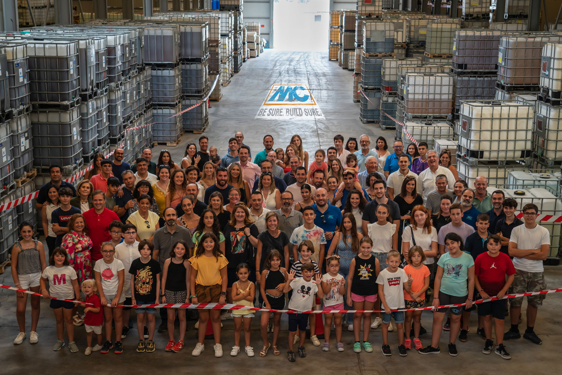 Abschlussfoto vom Familientag mit allen großen und kleinen Gästen in die Lagerhalle der MC-Bauchemie Spanien.